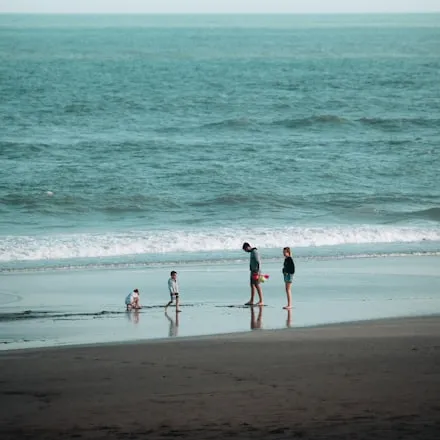 Figures on a wide empty beach