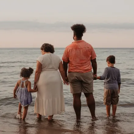 A family standing in shallow water