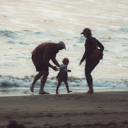 An adult and a child playing on the beach