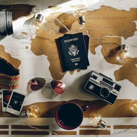 A camera and passport laid out on a map